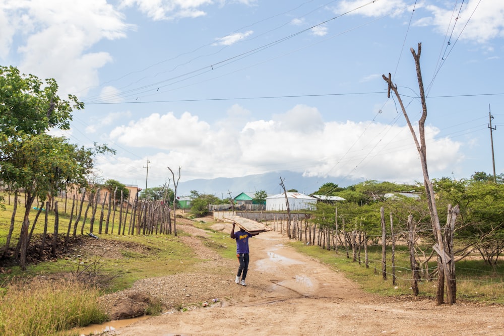 a person walking on a dirt road