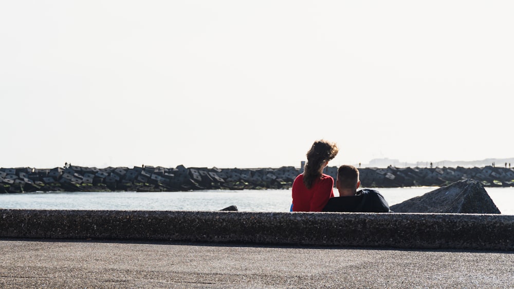 a couple sitting on a dock