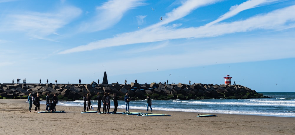 a group of people stand on a beach