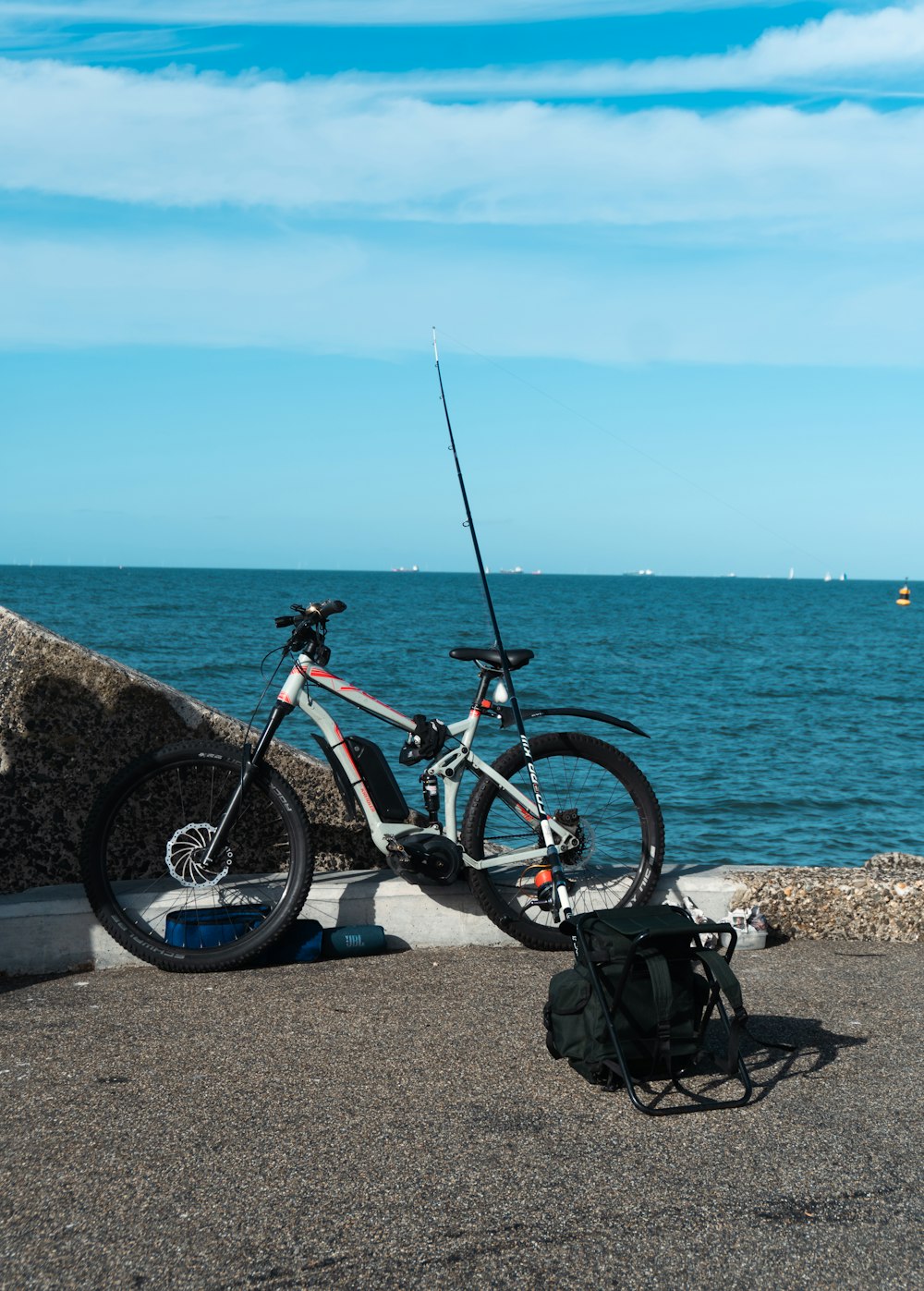 a couple of bikes parked on a rock by the water