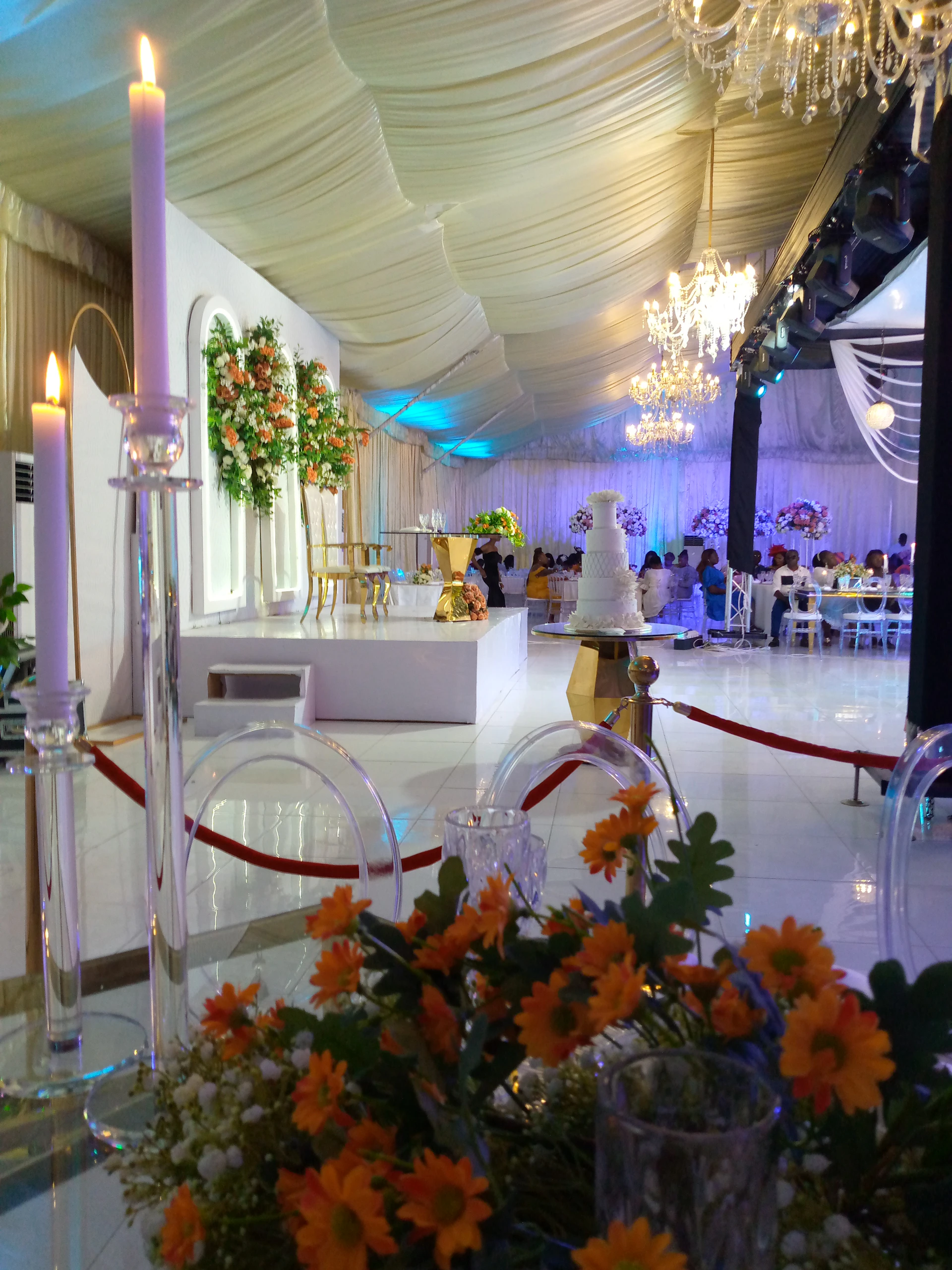 a large room with flowers and candles