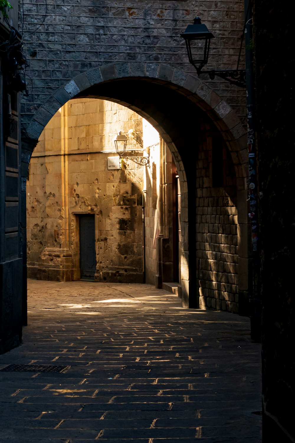 a brick walkway with a brick archway