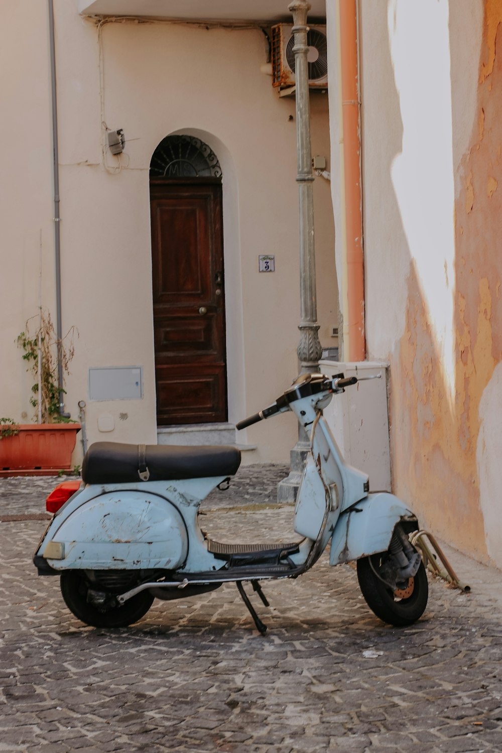 a moped parked outside a building