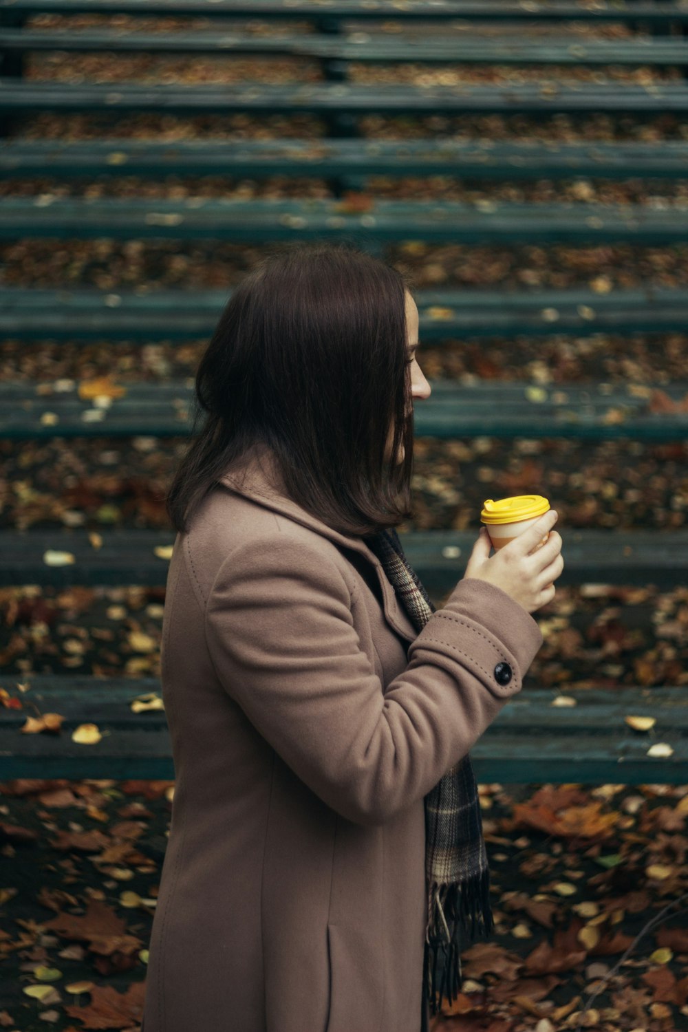 a woman holding a cup