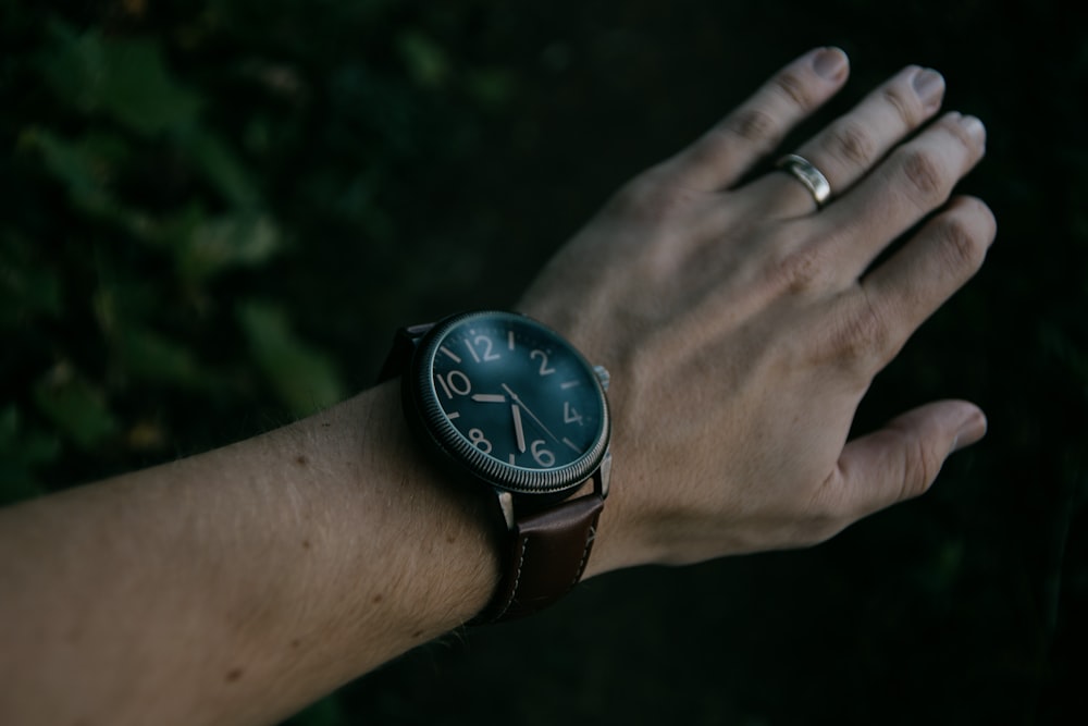 a person's hand with a watch on it