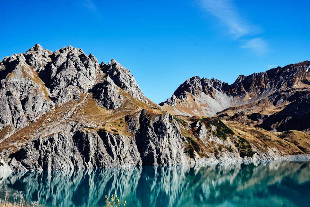 a body of water with mountains in the background