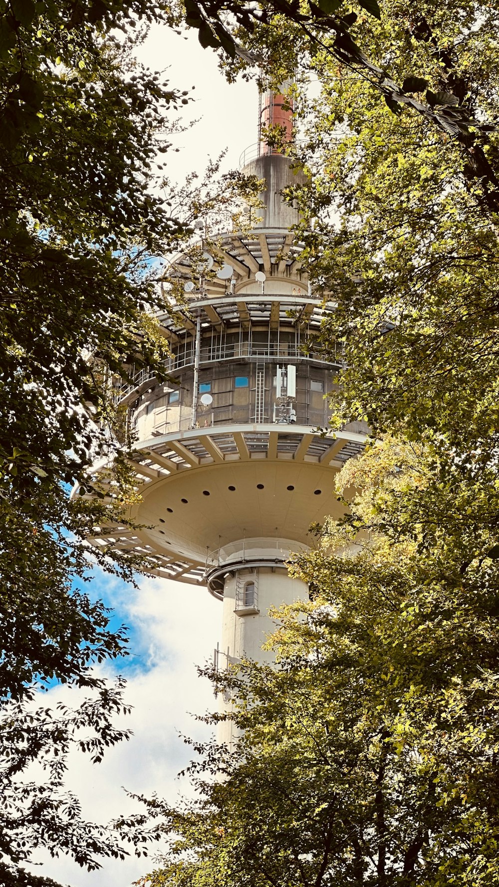 a tall tower with trees around it