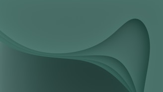 A smooth, abstract design featuring overlapping, gradient curves and shapes in varying shades of green.