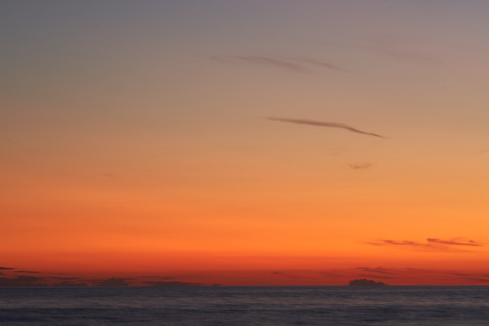 a sunset over a body of water