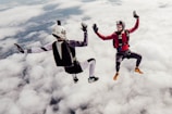 Skydivers freefalling against a bright blue sky, capturing the thrill of flight.