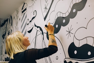 a person drawing on a white board