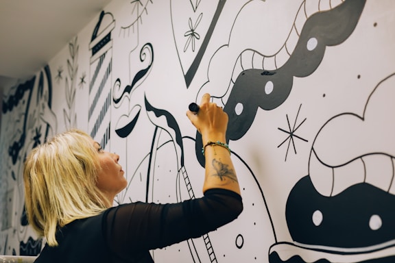a person drawing on a white board