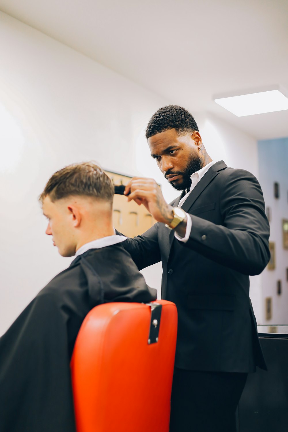 a man cutting another man's hair