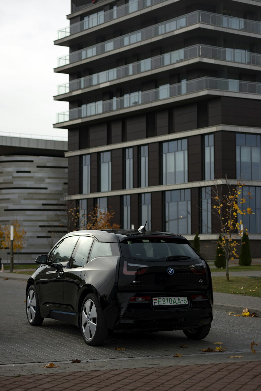 a black car parked in front of a building