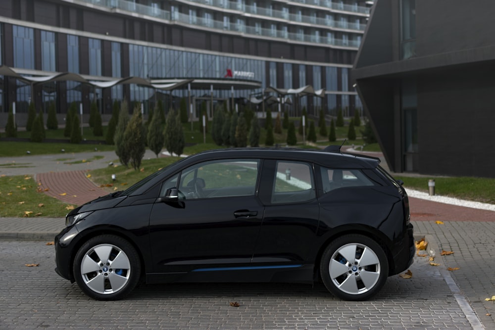 a black car parked in front of a building