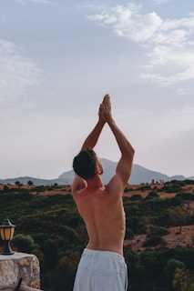 a man with his hand up in the air above a valley