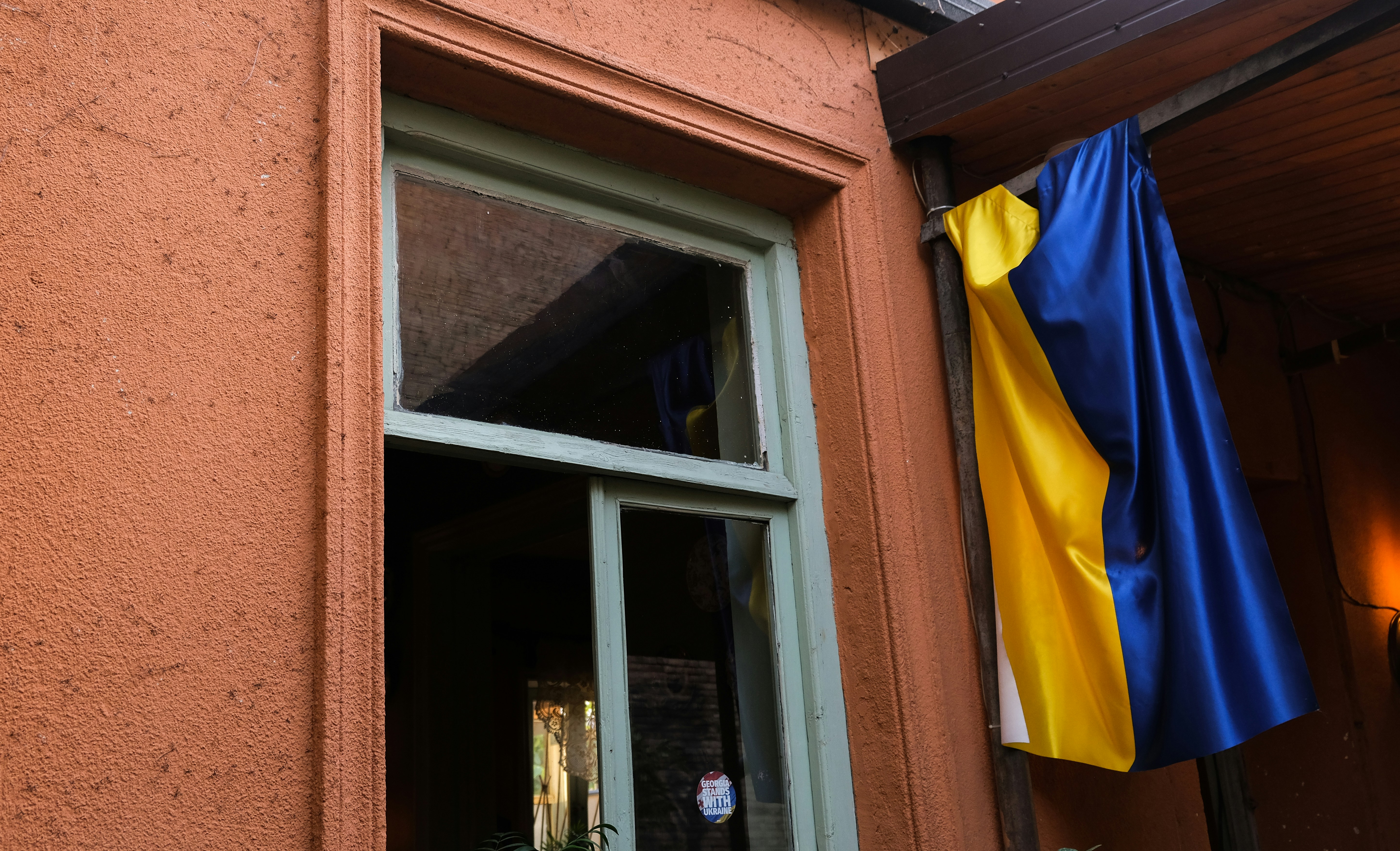 a blue flag from a window