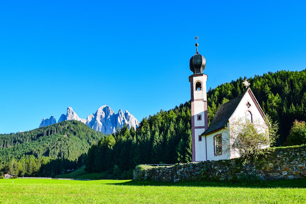 eine kleine Kirche auf einem grasbewachsenen Feld