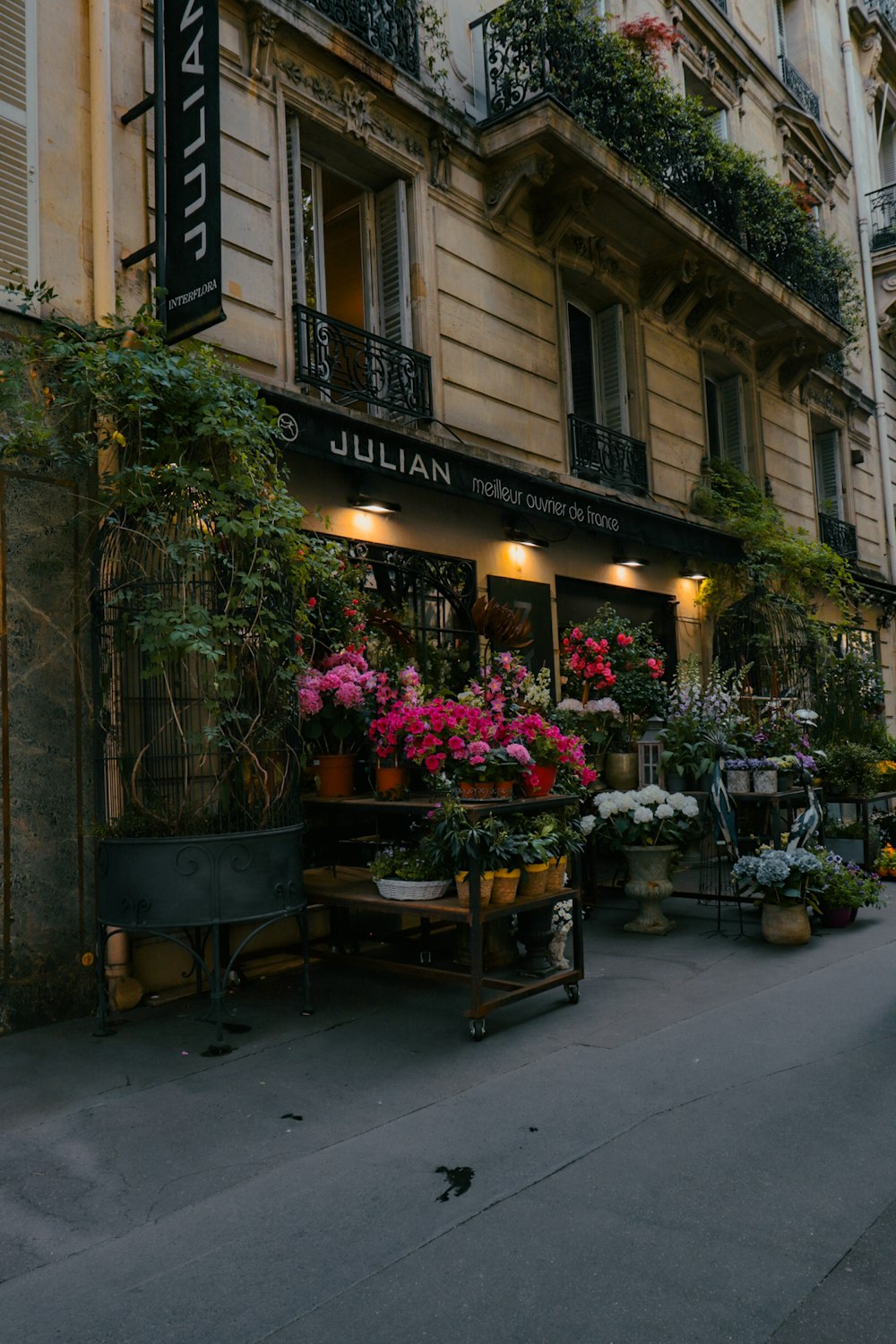 a building with a sign and flowers