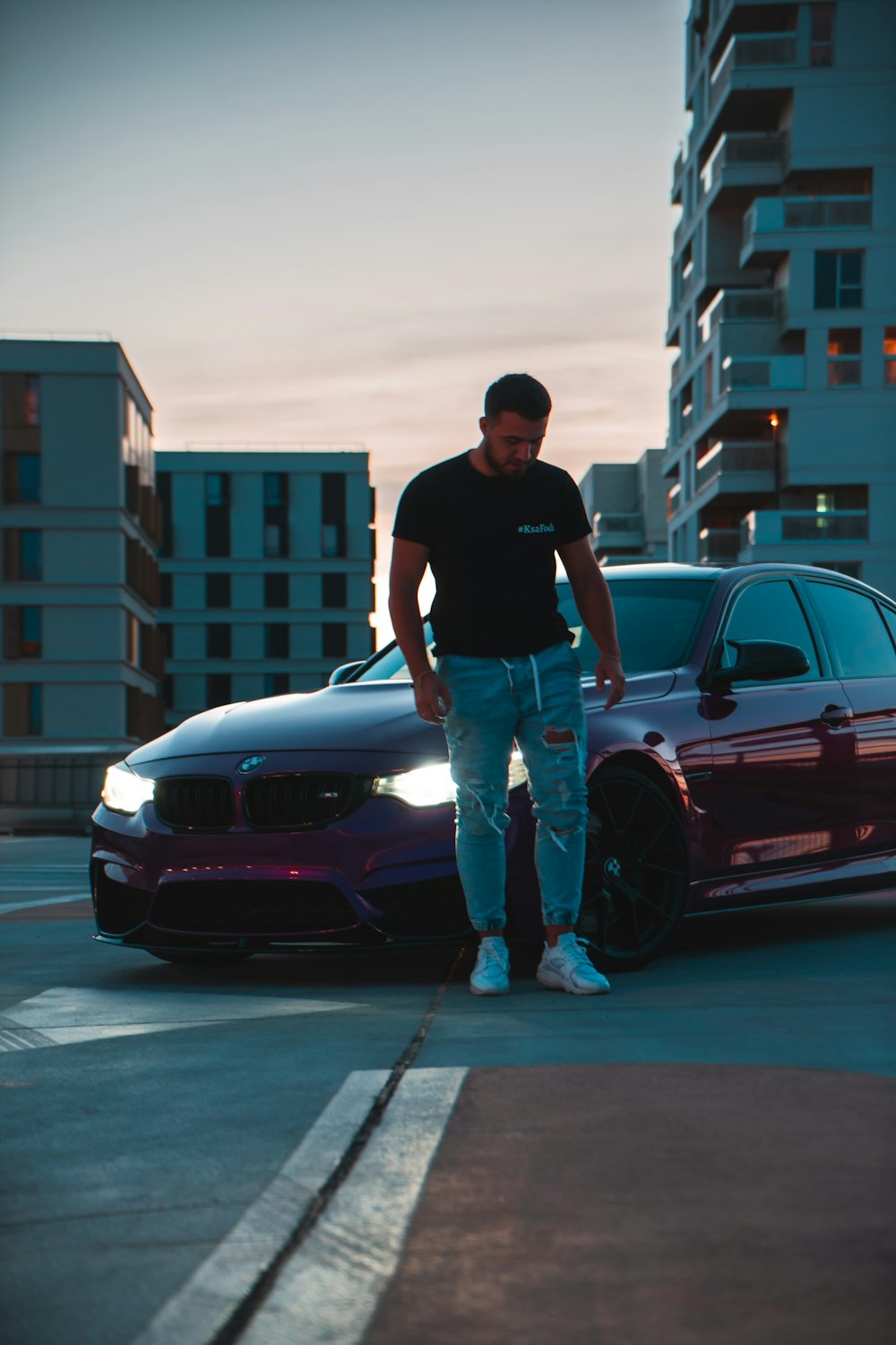 a man standing next to a car