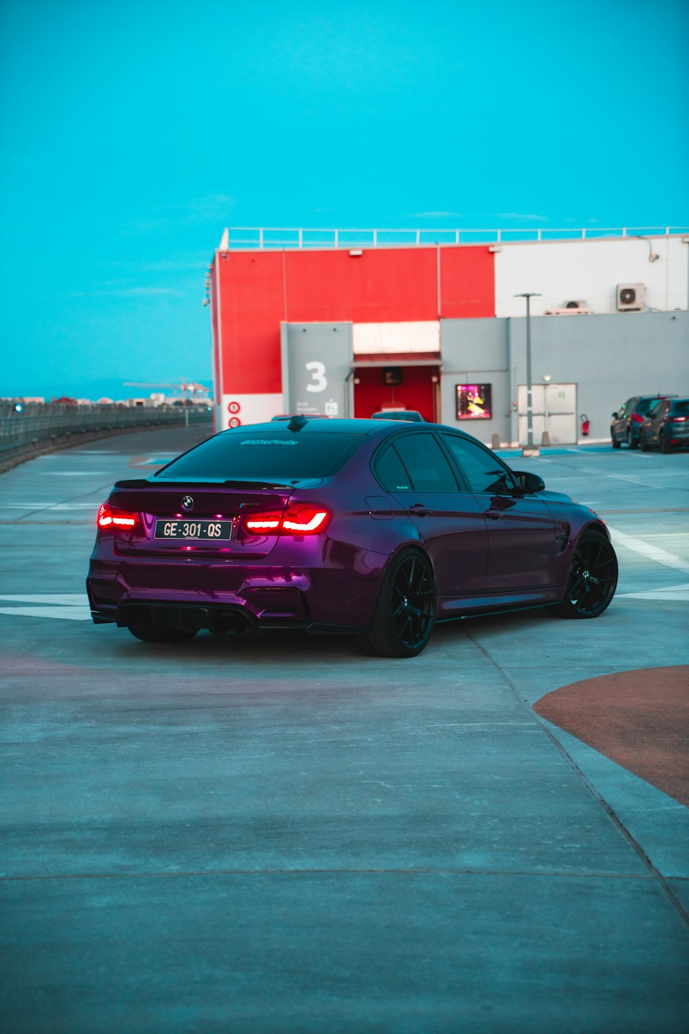 a purple car parked in front of a building