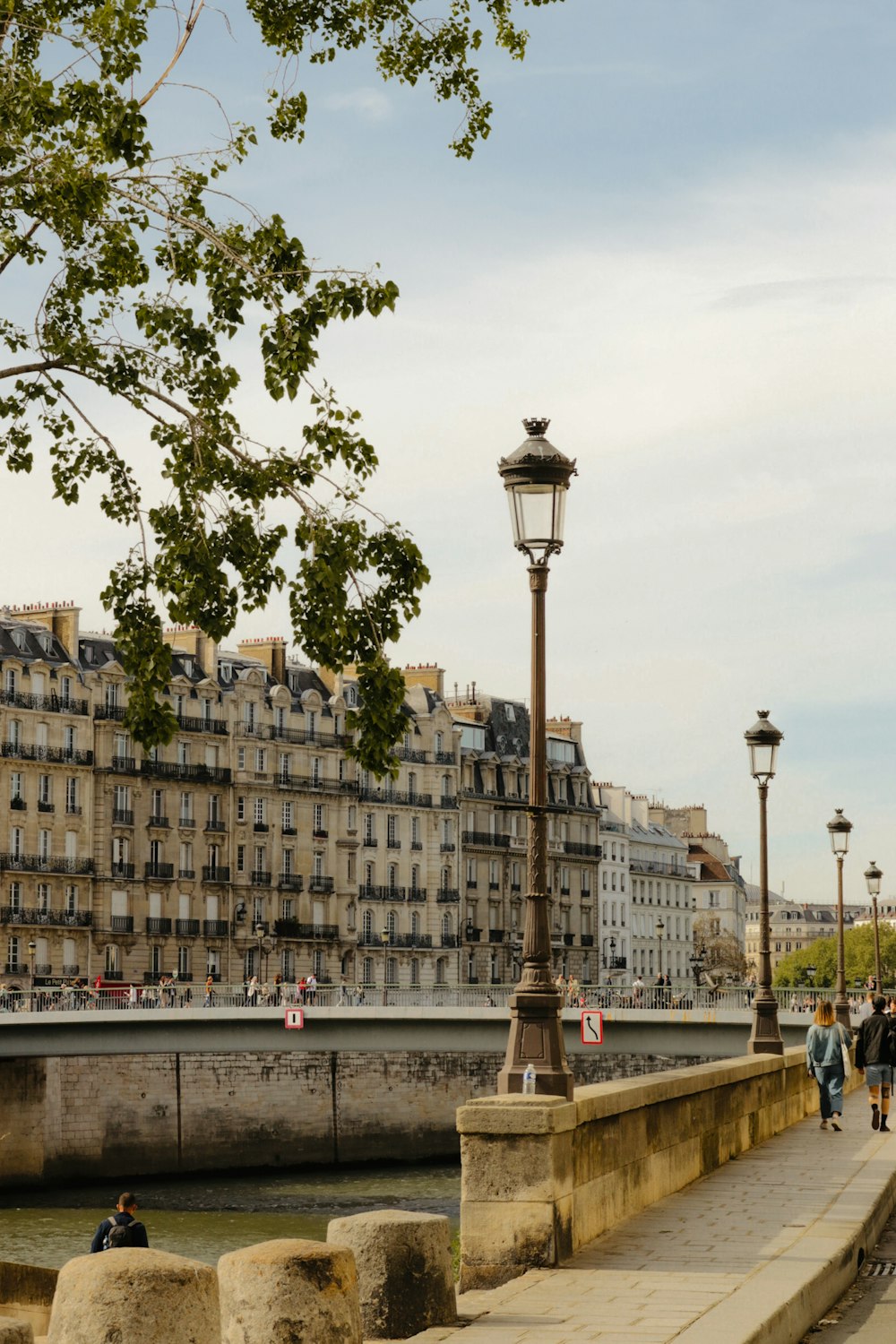 a tall lamp post in front of a building