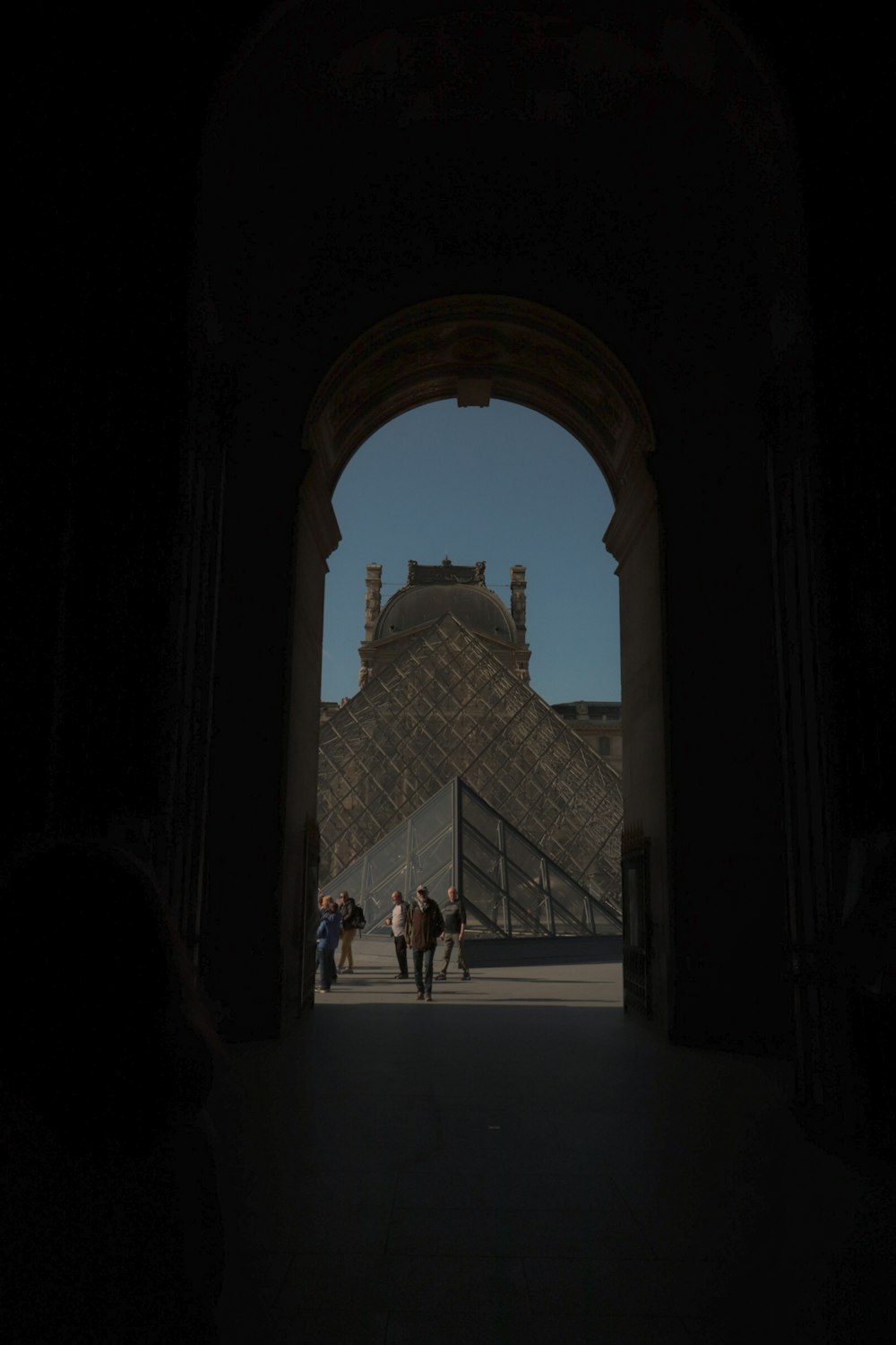 a group of people walking through a tunnel