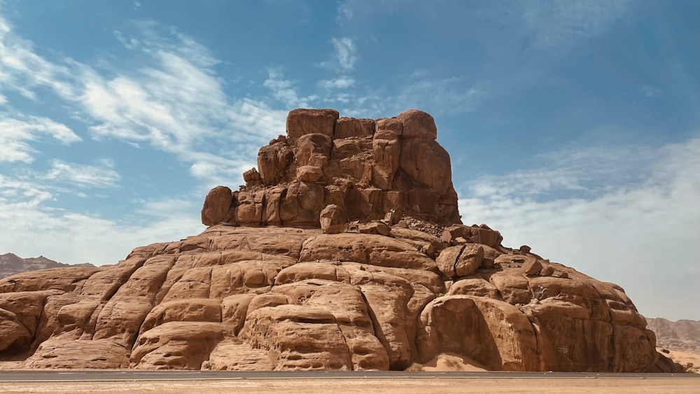 a large rock formation with Bell Rock in the background