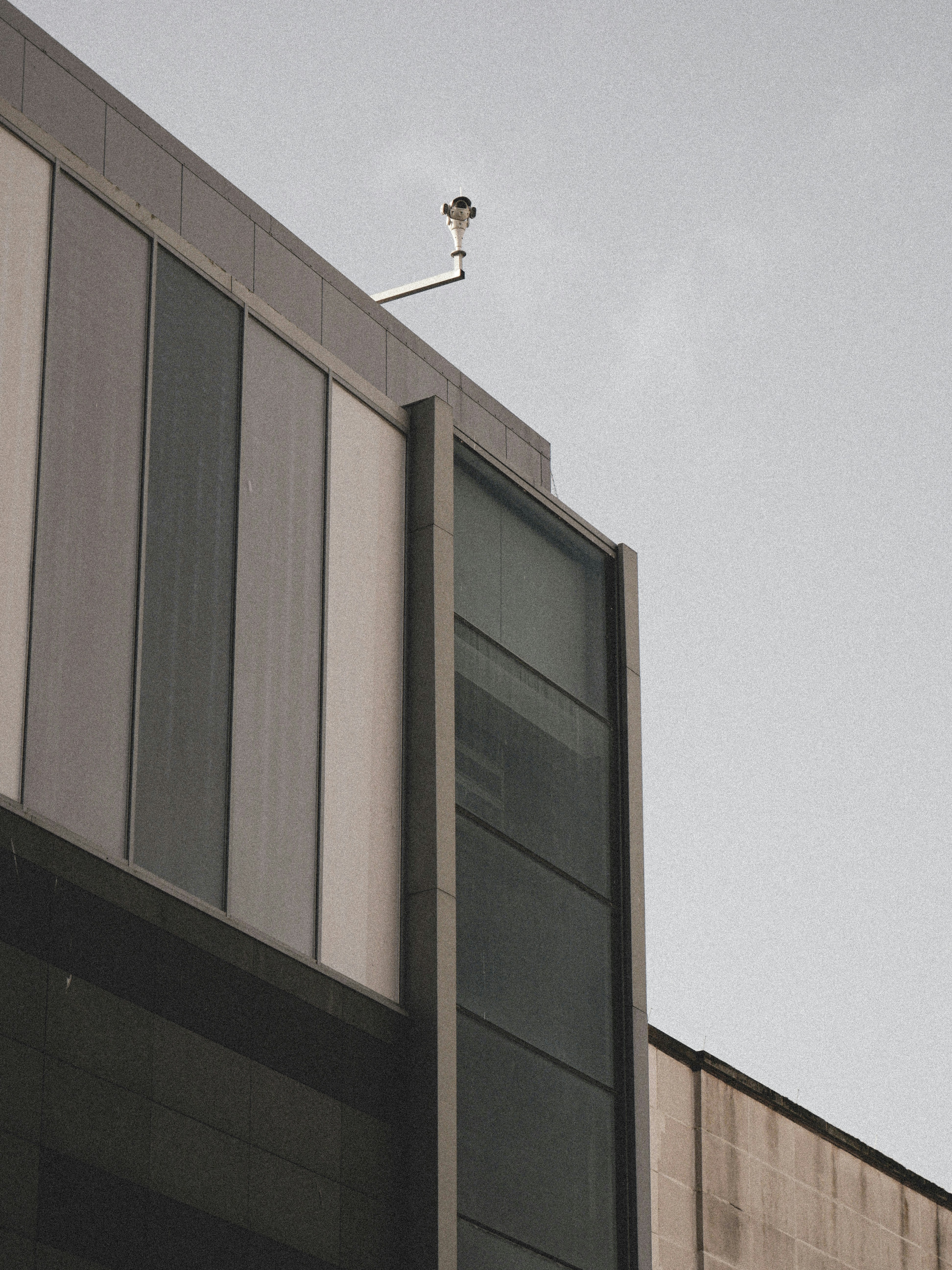 A Trustswift project manager on-site with a client, pointing at architectural blueprints against the backdrop of a building under construction in the UK.