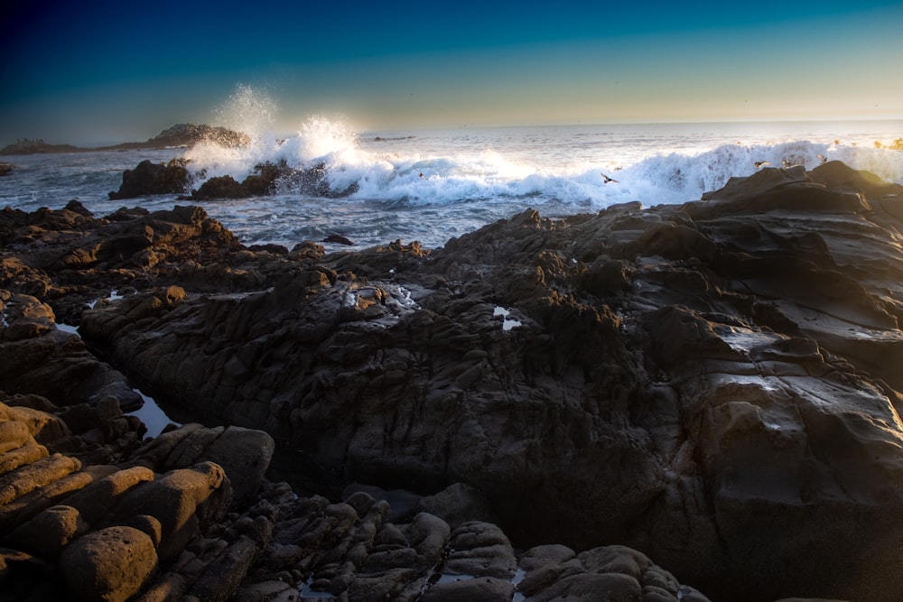 a rocky beach with waves crashing