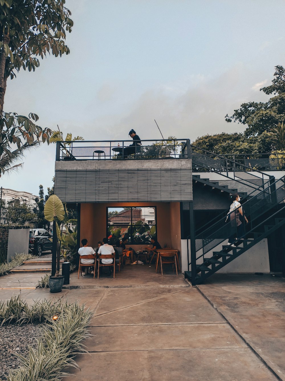 a group of people sitting at a table outside a building