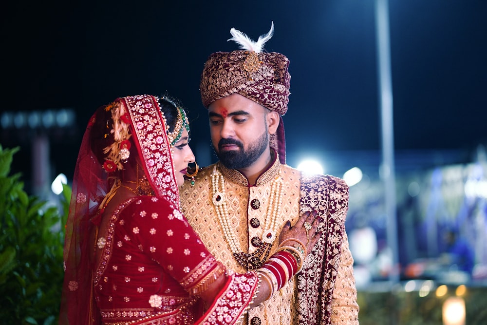 a man and woman wearing traditional clothing