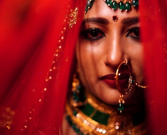 a woman with a colorful headdress and a red background