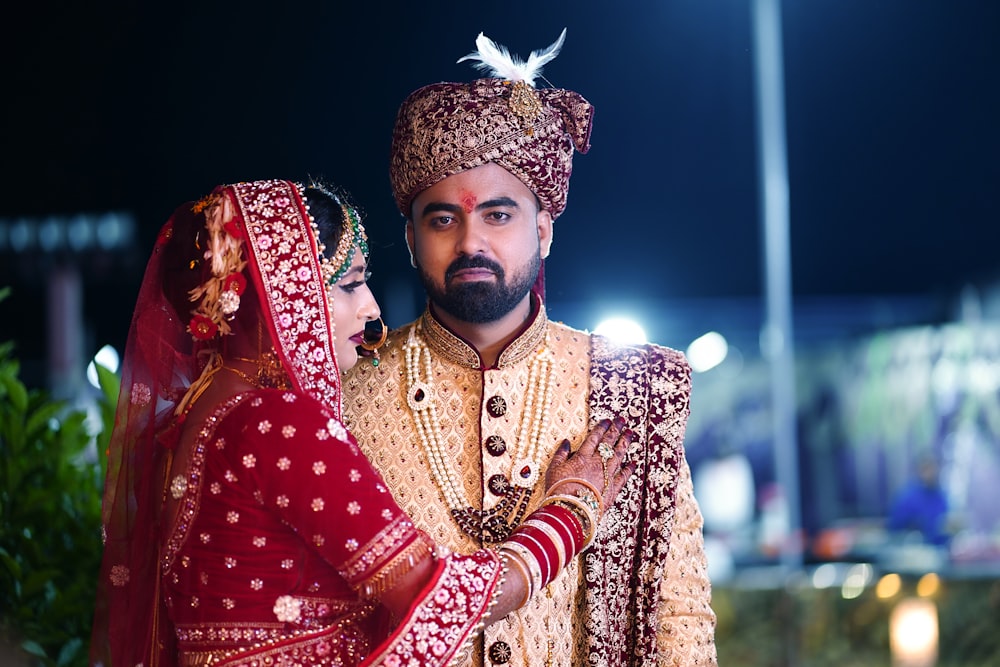 a man and woman wearing traditional clothing