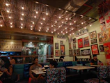 A cozy restaurant interior with guests enjoying diverse dishes.