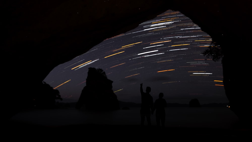 a group of people standing on a road at night