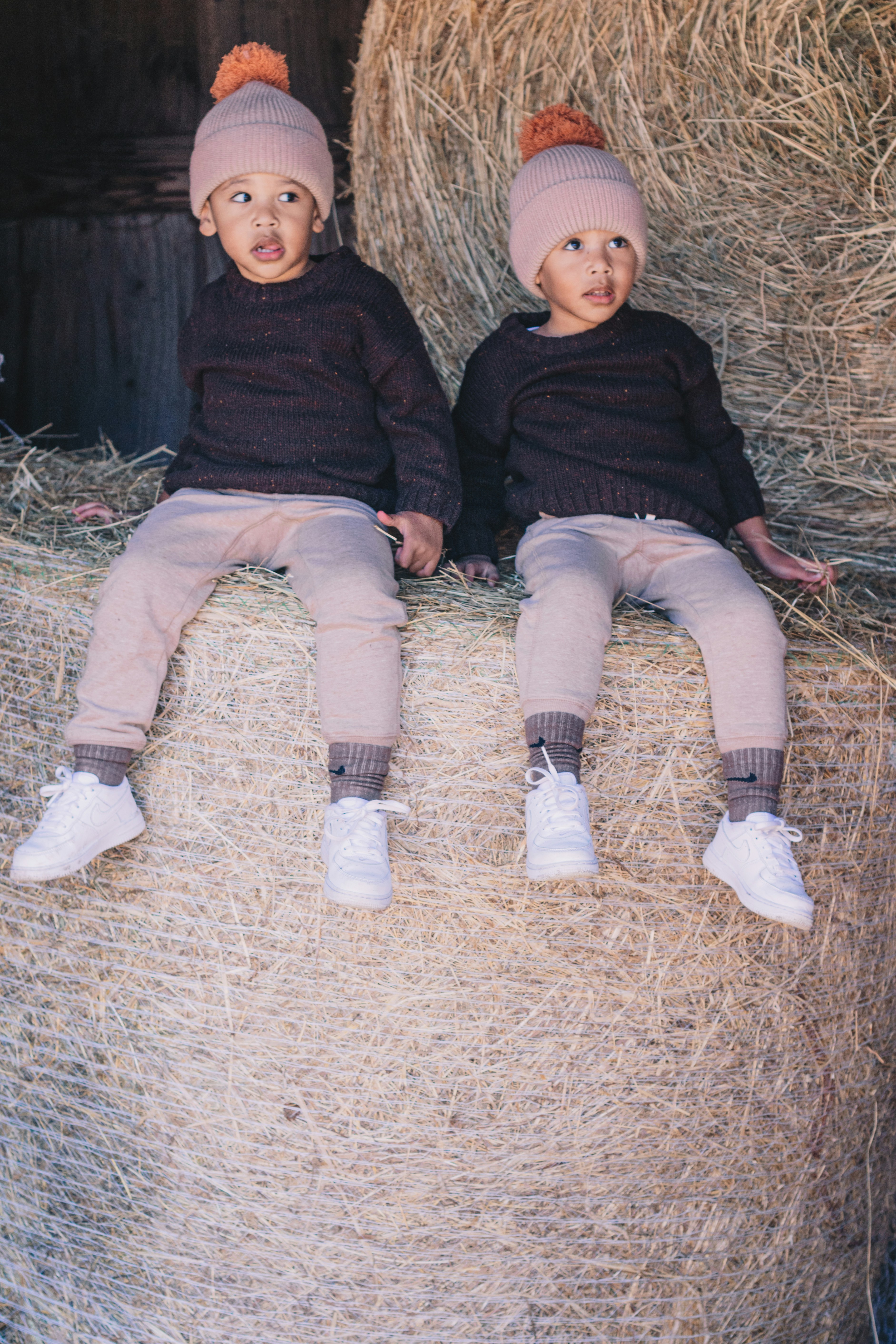 two children sitting on hay