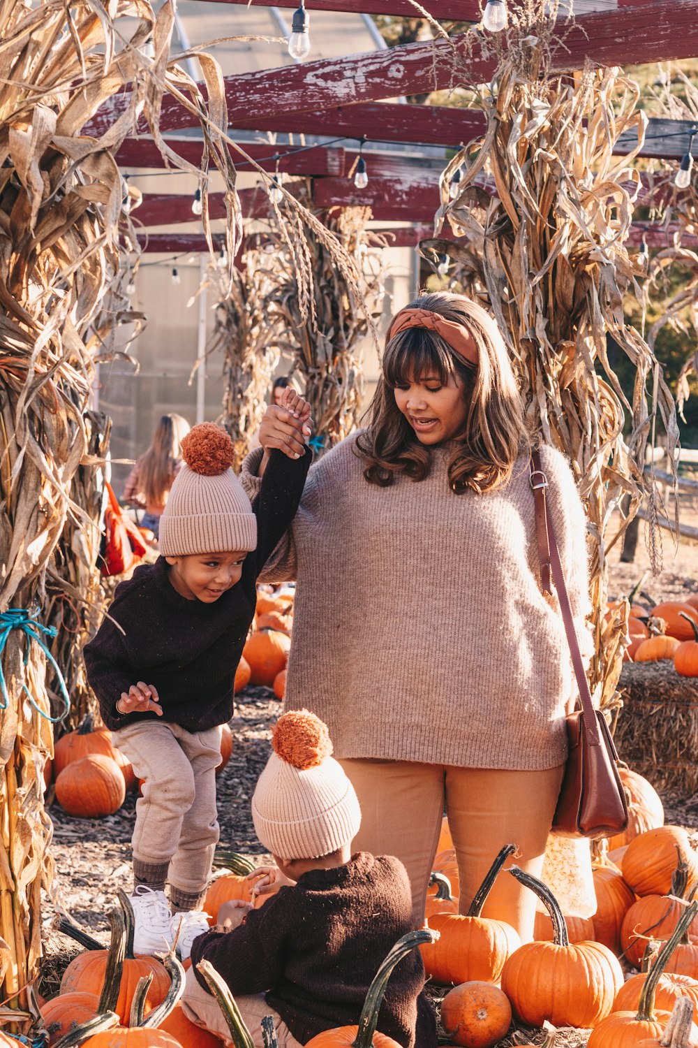 a person and a child in a pumpkin patch
