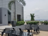 Outdoor seating space surrounded by greenery at a work center.