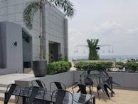 An outdoor seating area surrounded by greenery.