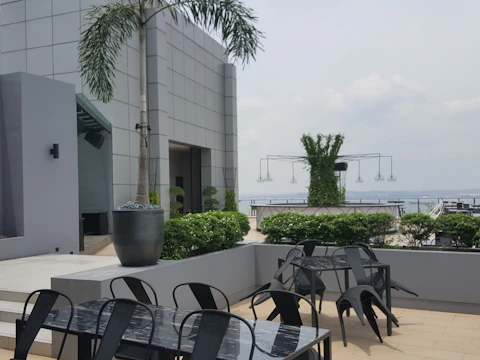 Outdoor terrace with comfortable seating and greenery.