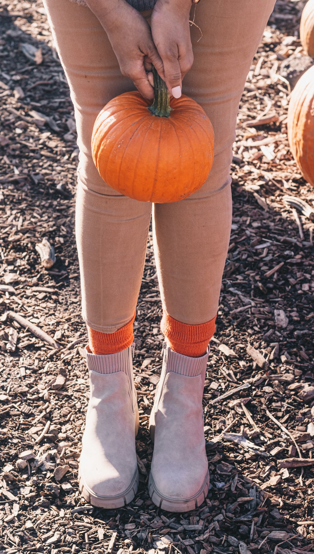 a person holding a pumpkin