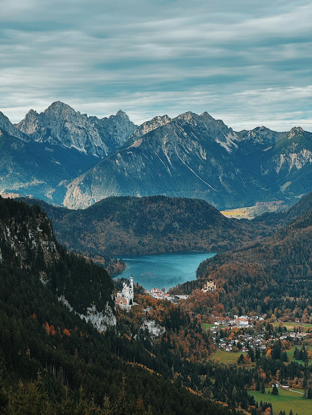 a town by a lake between mountains