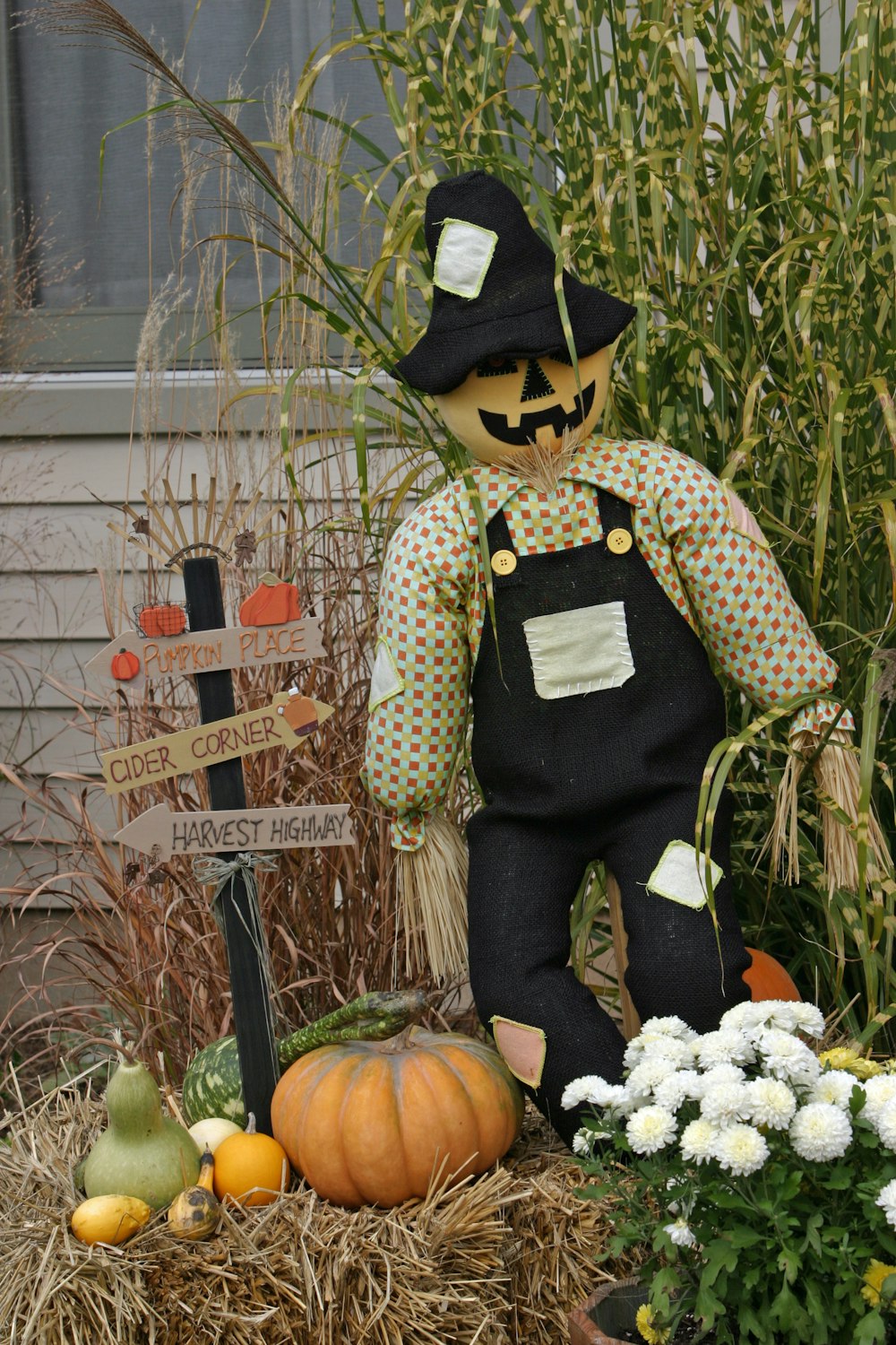 a scarecrow with a hat and a scarf