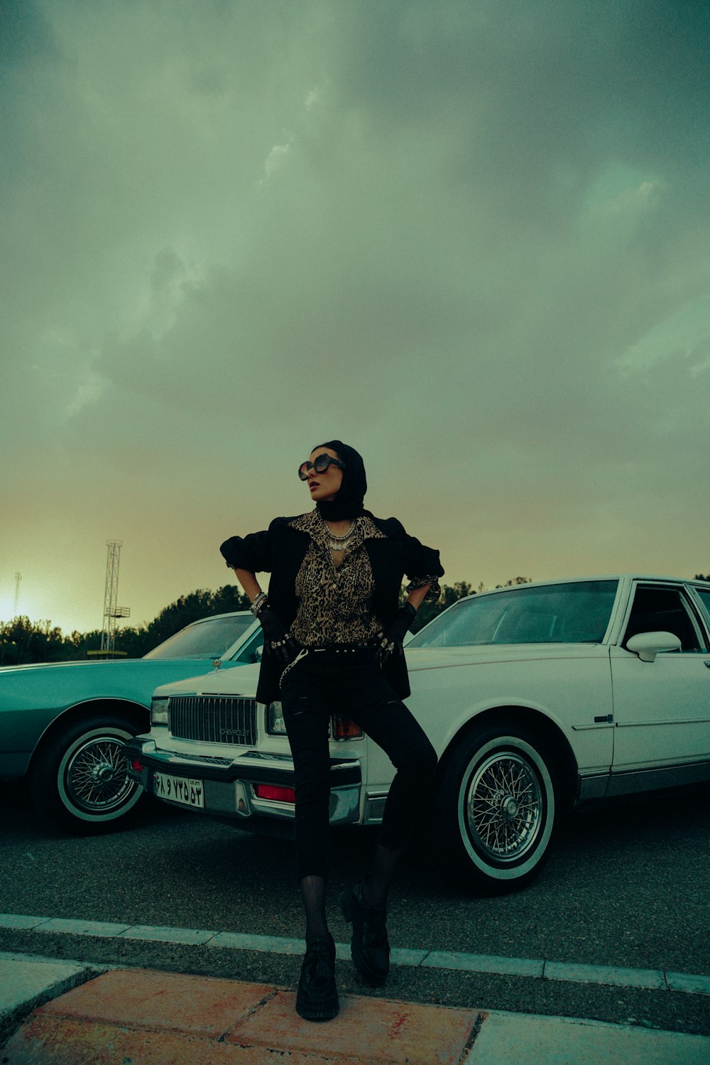 a person posing in front of a car