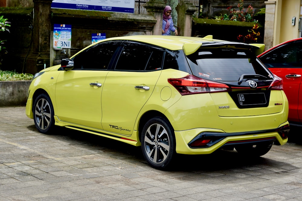 a yellow car parked on a street