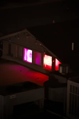 An urban rooftop at night with subtle city lights and a hint of a live show setup.