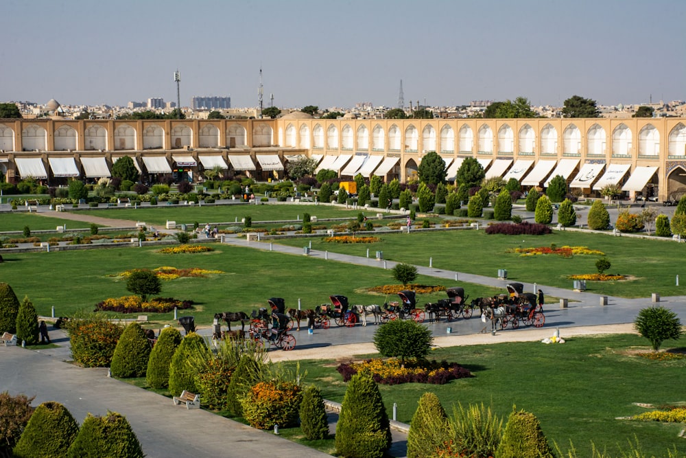 a large building with a lawn and trees in front of it