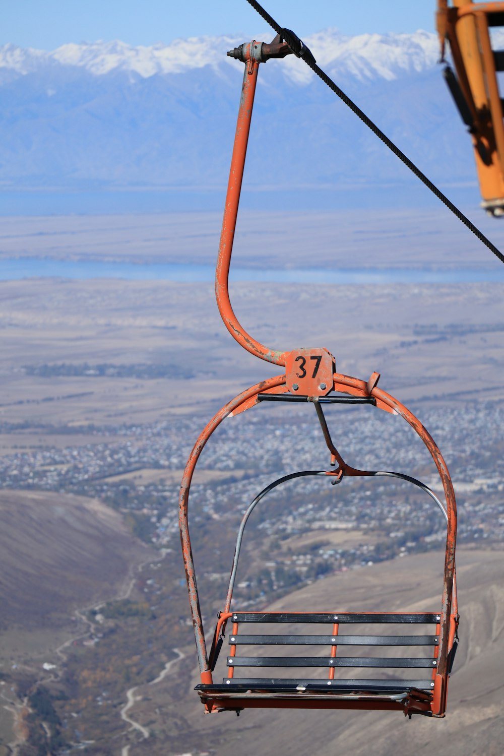 a chair suspended above a mountain