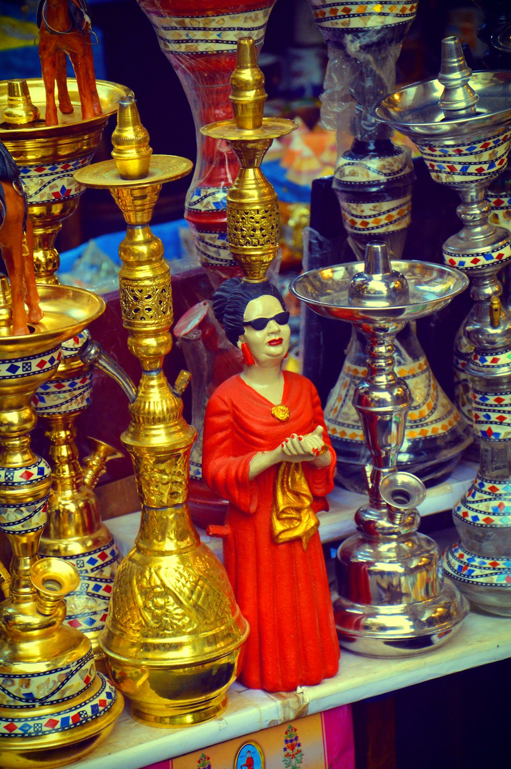 a statue of a person in a red dress and crown